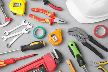 Flat lay composition with construction tools on light grey background