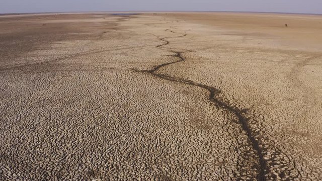 Climate change.Aerial fly over tilt-up view showing the level of devastation of what is left of these usually abundant waters of Lake Ngami,due to drought and climate change, Okavango Delta, Botswana