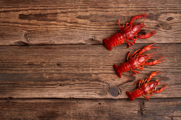 Boiled crayfishes on vintage rustic wooden table. Top view