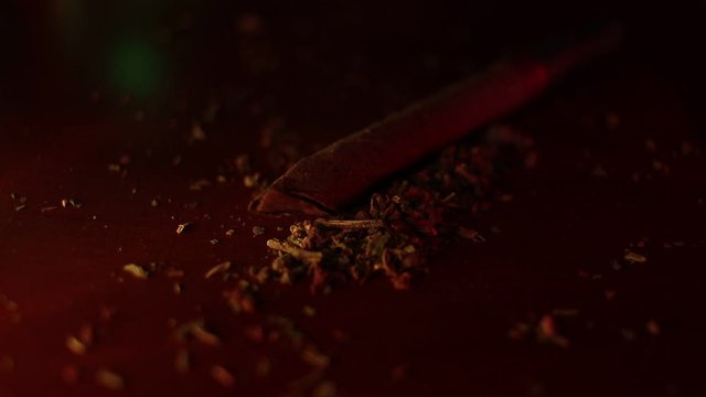 marijuana on the table, preparing to twist the jamb
