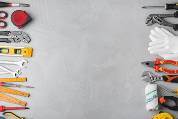 Flat lay composition with construction tools on light grey background. Space for text