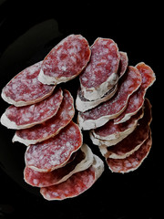 slices of Catalan fuet on a black plate