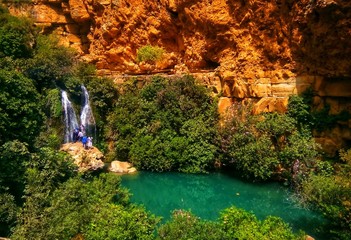 Beatiful waterfall  and small lake in algeria with green trees