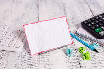 Notepaper stand on buffer wire in between computer keyboard and math sheets