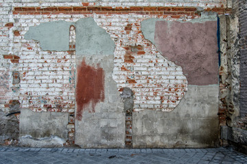 old chipped brick wall on a dead end street