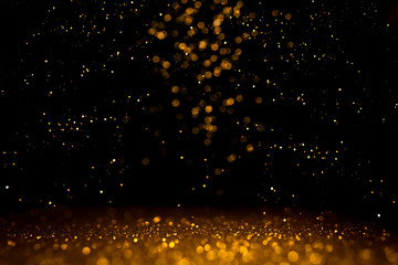 Golden abstract bokeh on black background.