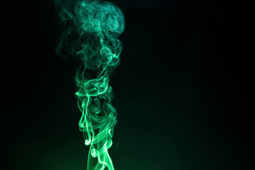 Colored smoke on black abstract background.