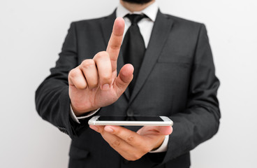 Male human wear formal work suit hold smart hi tech smartphone use one hand