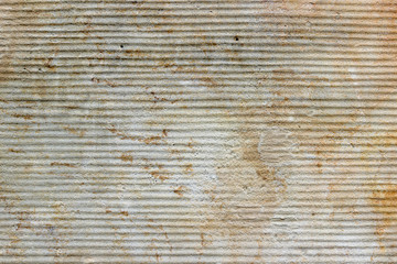 An old wall made of sandstone with a wavy surface