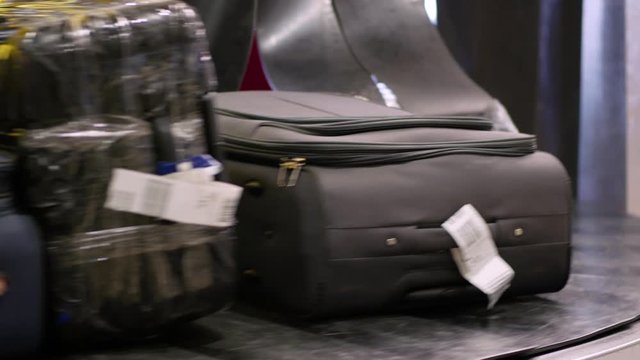 Baggage carousel. Bags, suitcases and other luggage moves on conveyor belt at the baggage reclaim area at an arrival airport.