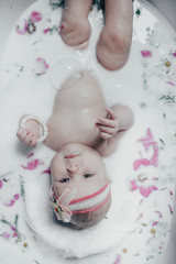 baby in milk with flowers