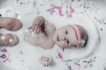 baby in milk with flowers