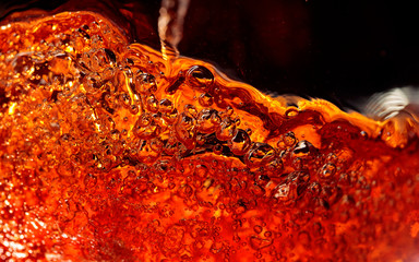Alcoholic drink on a dark background, abstract splashing.