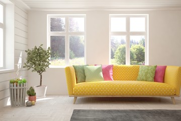 Stylish room in white color with sofa and summer landscape in window. Scandinavian interior design. 3D illustration