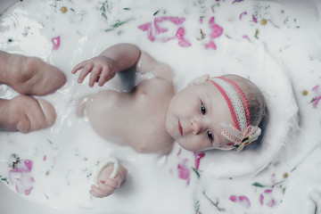 baby in milk with flowers