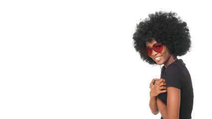 Smiling afro girl in red glasses and black shirt.