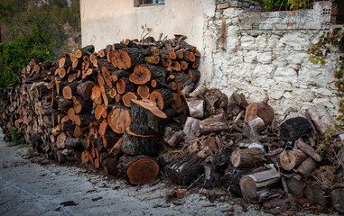 Stack of fire hardwood used to make charcoal or burned in a fireplace for heating during wintertime.