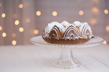 homemade cake with blurred lights background. cake with sugar powder.