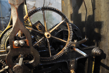 The mechanism of the old clock mounted on the town hall.