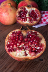 fresh ripe pomegranate open on wooden background, fruits