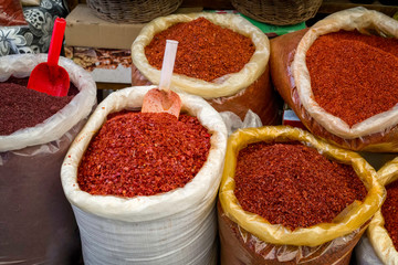 different types of red peppers in bags at a traditional turkish street market