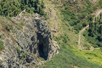 Los roques and famous Agando rock - cult place near Garajonay national park at La Gomera. Old volcanic mountain peaks. Thickets of relic laurels and heather on steep green slopes. Canary. Spain