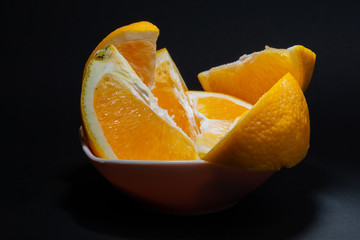 slices of juicy orange on a black background