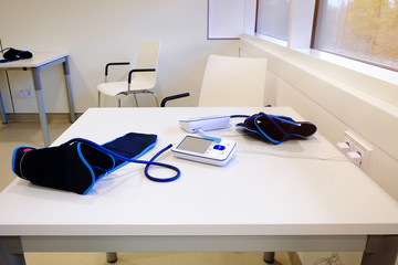 White electric blood pressure monitor on the table for measuring blood pressure. Healthy concept