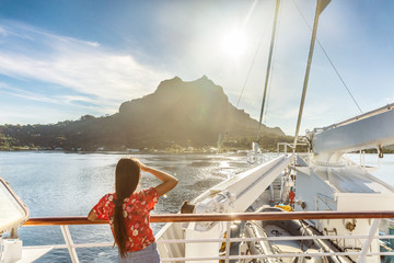 Bora bora island luxury cruise ship travel tourist woman watching sunset on balcony deck of Europe...