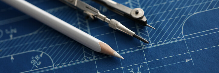 Drawing tools lying over blueprint paper