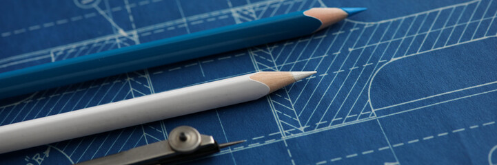 Drawing tools lying over blueprint paper