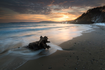 Dreamy seascape during sunset. Beautiful natural seascape. Sea sunset at a lake coast near Varna, Bulgaria. Magnificent sunset with clouds in the middle of spring The concept of leisure and freedom.