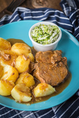 Braised meat in sauce served with boiled potatoes.