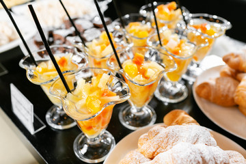 Breakfast buffet. Fresh fruit cocktail in glasses. Dessert with pieces of fruit. Morning hotel breakfast buffet.