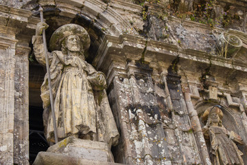 Fototapeta premium Santiago de Compostela, Spain - 10\13\2018: medieval statue of Saint Jacob at the church facade. Symbol of pilgrimage and travel. Monument of catholic saint James in Santiago de Compostela. 