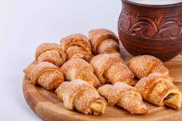 pile of fresh and delicious kroissants and rolls on a white background