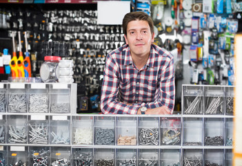 Portrait of smiling seller working with manufacturing keys