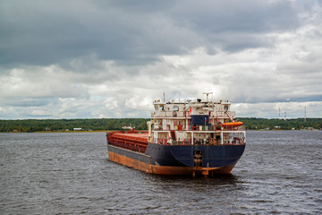 Fototapeta premium Barges with cargo swimming along the banks of the north-west river