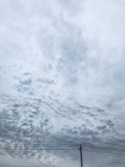 Cloudy sky behind of electric street lamp at rainy day