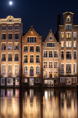 Traditional Dutch buildings at Damrak at night, Amsterdam, Netherlands