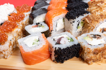 Set of rolls with salmon, red caviar, and flying fish. With krill. Close-up
