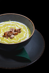 Creamy decorated vegetable soup in a rustic bowl 