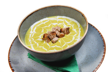 Creamy decorated vegetable soup in a rustic bowl 
