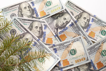 100 dollars with Christmas tree on wooden white table. money gift for Christmas day. money dollar bills close-up , top view. concept Business Finance holiday Happy bonus in December. copy space