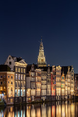 Traditional Dutch buildings at Damrak at night, Amsterdam, Netherlands