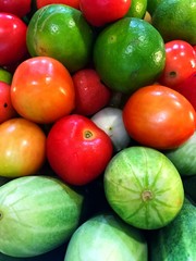 Organic fresh cucumbers,limes and tomatoes are nutritious, crunchy, and refreshing.