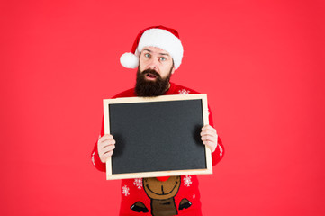 New year and Christmas publicity. Bearded man hold blank publicity board. Santa Claus display school publicity. Publicity and education, copy space