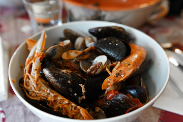 Luxury royal prawns roasted with variety of seafood in expensive restaurant. Mediterranean culture, traditional seafood in culinary. Plate full of delicious healthy seafood
