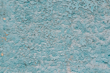 An old stone wall with peeling blue mint paint.grunge.Texture. Photo background.Textile.New year and Christmas