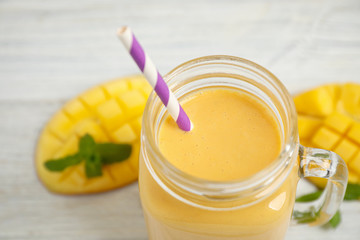 Fresh delicious mango drink on table, closeup